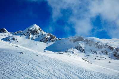 Scenic view of snowcapped mountains against sky