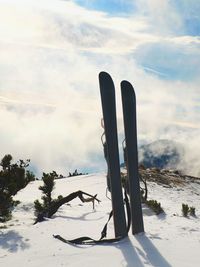 Small fun skis in snow at mountains, nice sunny winter day at peak
