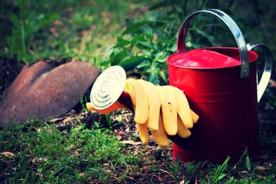 Watering can with gloves on field