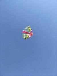 Low angle view of pink umbrella against clear blue sky