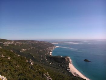 High angle view of mountain by sea against clear sky