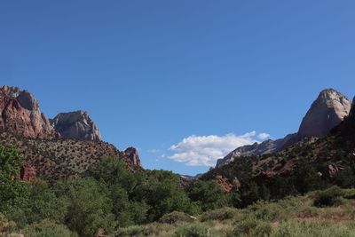 Scenic view of mountain against blue sky