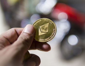 Close-up of hand holding coins