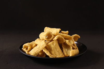 Close-up of food in bowl against black background