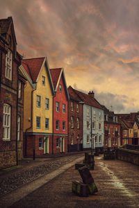 Buildings against cloudy sky