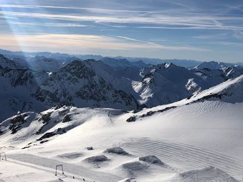 Scenic view of snow covered mountains against sky