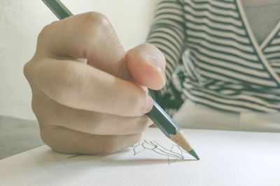 Close-up of hand holding paper