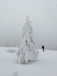 Scenic view of snow covered field against sky