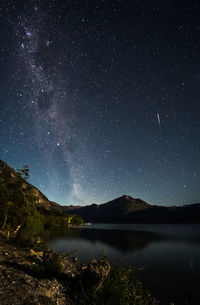 Scenic view of lake against star field at night