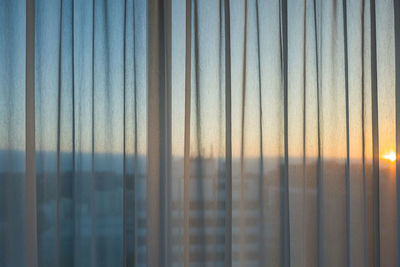 Sky seen through curtain during sunset