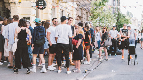 Group of people standing on street in city