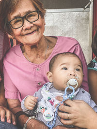 Smiling senior woman with baby boy