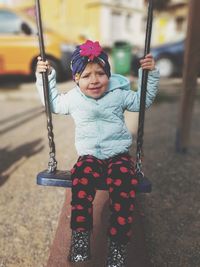 Cute girl holding camera at playground