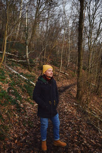 Portrait of man standing in forest