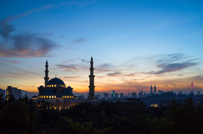 Federal territory mosque against cloudy sky at dusk