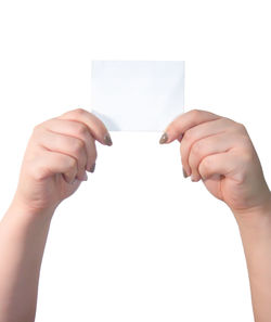 Midsection of person holding paper against white background