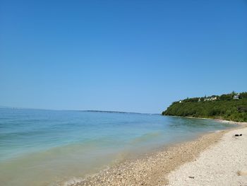 Scenic view of sea against clear blue sky