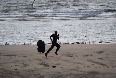 Beach body ready 
people playing on beach against sea