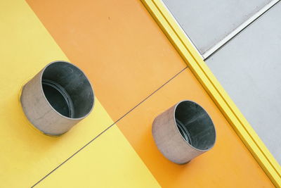 High angle view of yellow shoes on wall