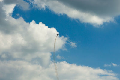 Low angle view of airplane flying against sky