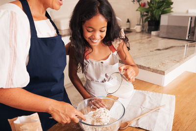 Young woman preparing food at home