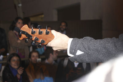 Cropped hand of man playing guitar