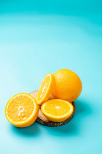 Oranges photographed on a light blue background.