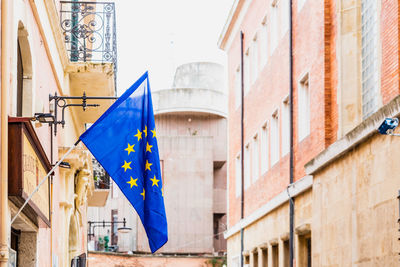 Low angle view of flags hanging on building