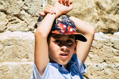 Full length portrait of boy on rock