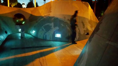Illuminated tunnel at night