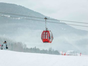 Overhead cable car against sky during winter