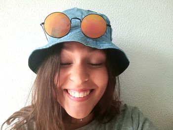 Close-up portrait of smiling young woman at home