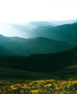 Scenic view of landscape and mountains against sky