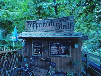 Bicycle sign against trees