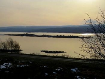 Scenic view of lake at sunset