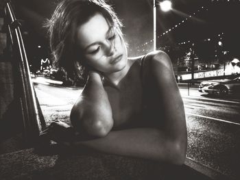 Girl on road in illuminated city at night