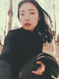 Portrait of young woman sitting outdoors