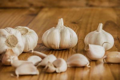 Garlic is a culinary and medicinal plant on a wooden background