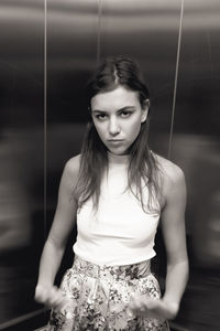 Portrait of beautiful young woman in elevator