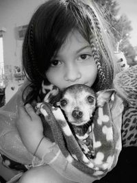 Portrait of cute girl with dog at home