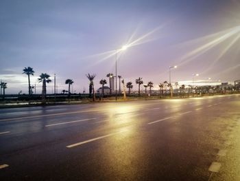 Cars on road against sky in city