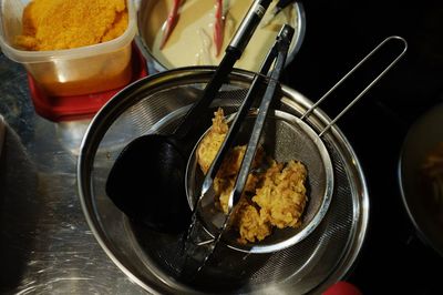 High angle view of food in colander on table