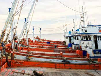 Boats moored at harbor by sea