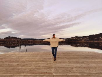 Rear view of woman standing at beach