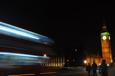 Blurred motion of illuminated clock tower at night