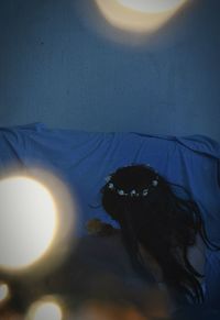 High angle view of woman lying down on bed