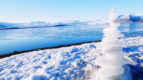 Frozen sea against sky during winter