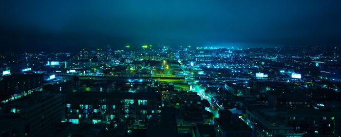 High angle view of city lit up at night