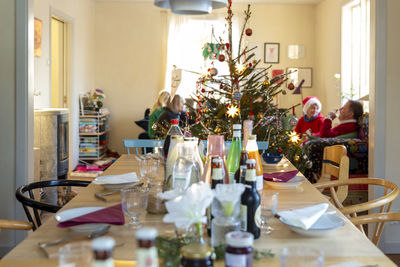 Family celebrating next to christmas tree