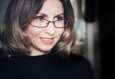 Close-up portrait of smiling young woman